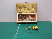Assorted router bits in craftsman wooden storage box