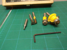 Assorted router bits in craftsman wooden storage box
