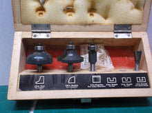 Assorted router bits in craftsman wooden storage box