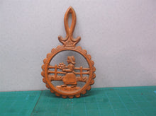 vintage orange metal trivet lady holding flowers