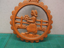 vintage orange metal trivet lady holding flowers