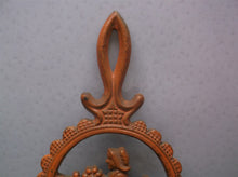 vintage orange metal trivet lady holding flowers