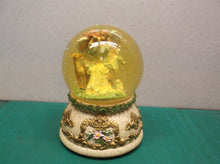 angle with animals musical snow globe. Plays "Waltz of the flowers"