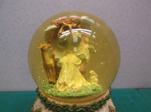 angle with animals musical snow globe. Plays "Waltz of the flowers"