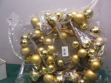 Gold christmas ball wreath has some dented balls