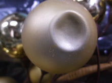 Gold christmas ball wreath has some dented balls
