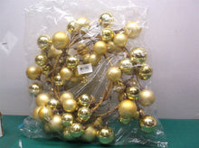 Gold christmas ball wreath has some dented balls
