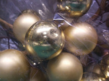 Gold christmas ball wreath has some dented balls