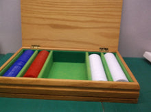set of poker chips in wooden storage box