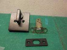 assorted black kwikset door knob parts