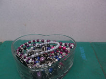 Glass heart shaped dish with costume jewelry