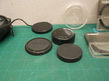lot of camera lenses caps & filters