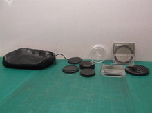 lot of camera lenses caps & filters