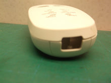 Button housing off a Calming Heat Massaging Weighted Heating Pad by Sharper Imag