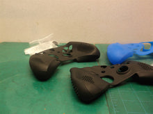 lot of 2 black controller and thumb stick covers and 1 blue controller and thums