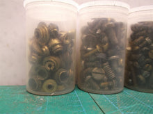 7 small jars of assorted clock parts