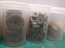 7 small jars of assorted clock parts