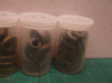 5 small jars of assorted clock parts