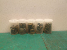 5 small jars of assorted clock parts