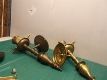 2 brass colored wall mount candle holder