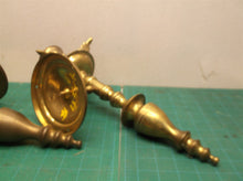 2 brass colored wall mount candle holder
