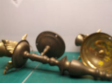 2 brass colored wall mount candle holder