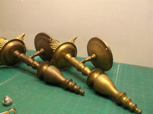 2 brass colored wall mount candle holder