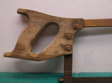 vintage hack saw with wooden handle