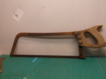 vintage hack saw with wooden handle