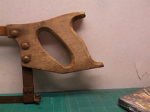 vintage hack saw with wooden handle