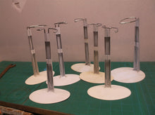 lot of 7 doll stands 6 oval base & 1 round base