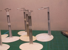 lot of 7 doll stands 6 oval base & 1 round base