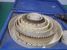 lot of 12 hole saws with 2 arbors
