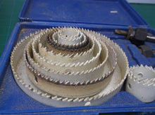 lot of 12 hole saws with 2 arbors