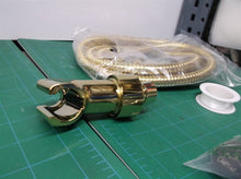 gold colored hand held shower hose set