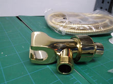 gold colored hand held shower hose set