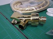gold colored hand held shower hose set