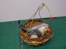 small fake blue bird and nest with green egg