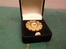 Tupperware ladies broch pin 1 " round with 7 stones in black box
