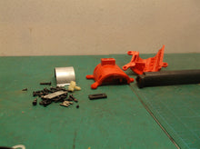 assorted parts off a Milwaukee 2475-20 M12 Compact Tire Inflator