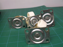 lot of 4 1.5" white and brass casters with 4 screw holes