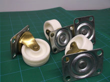 lot of 4 1.5" white and brass casters with 4 screw holes