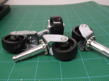 lot of 4 1-1/8" black casters with 25/64" diameter stems