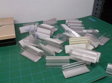 Lot of clear plastic shelf clips with hook & loop